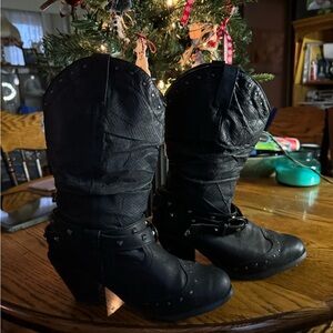 Mid high black heeled boots. The heel is a chunk heal.